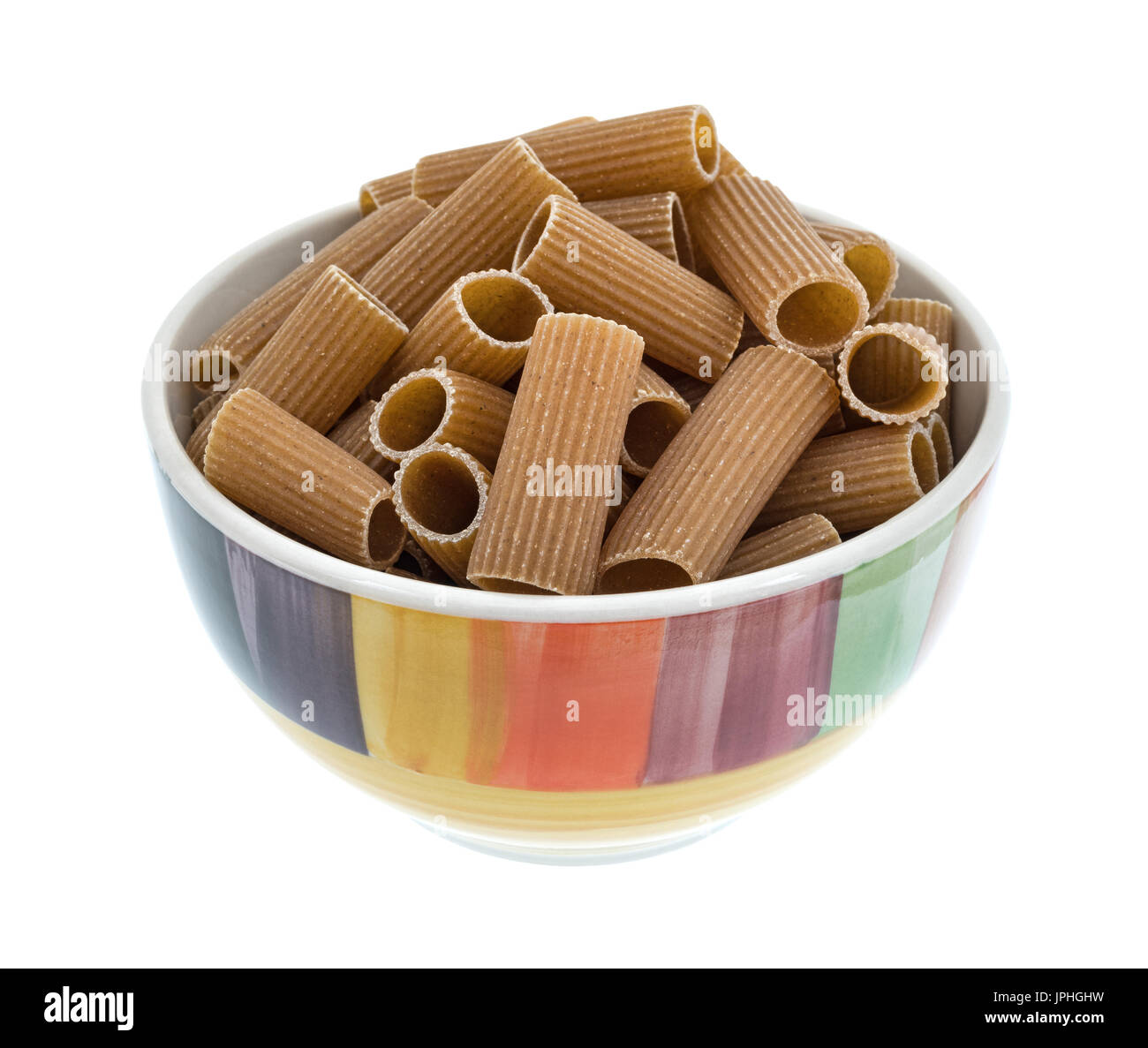 A colorful bowl filled with tube shaped whole wheat rigatoni isolated ...