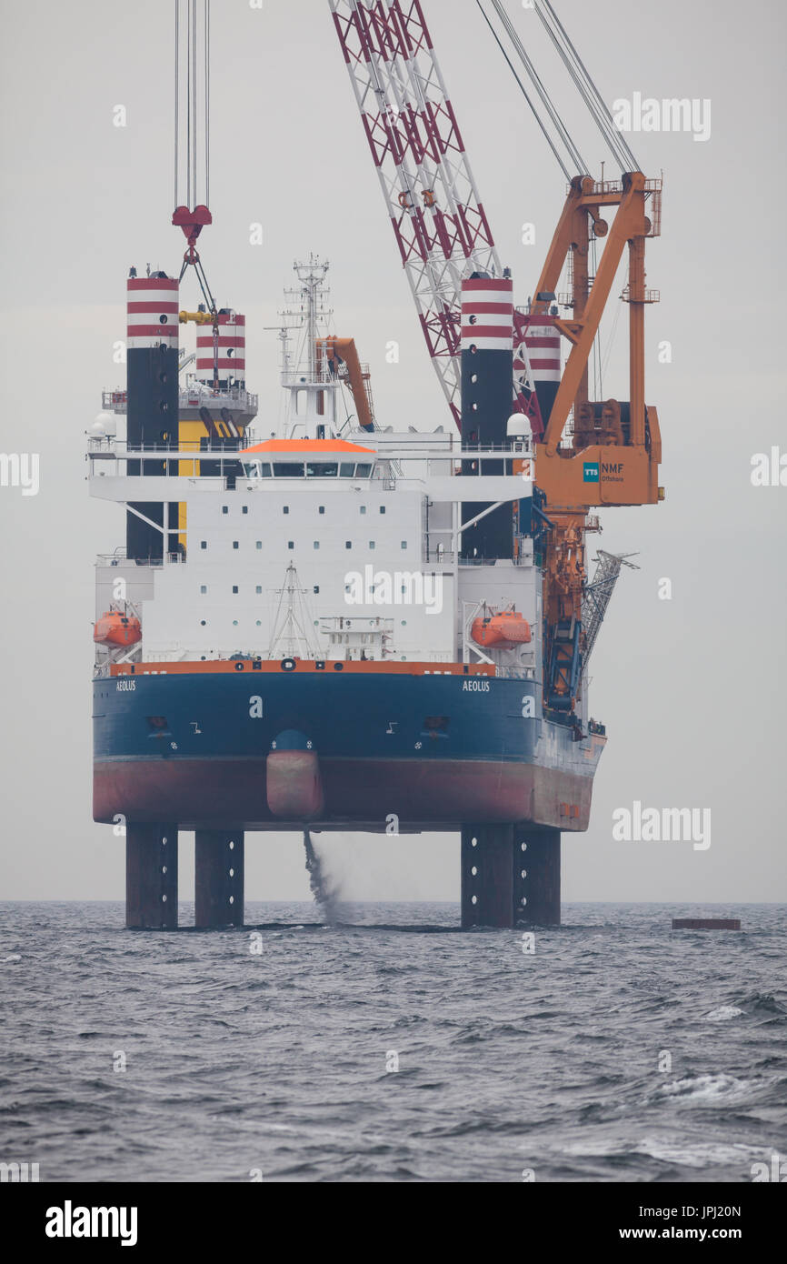 The jack-up vessel, Aeolus, installing the Transition Pieces (TP's) on the Walney Extension Offshore Wind Farm Stock Photo