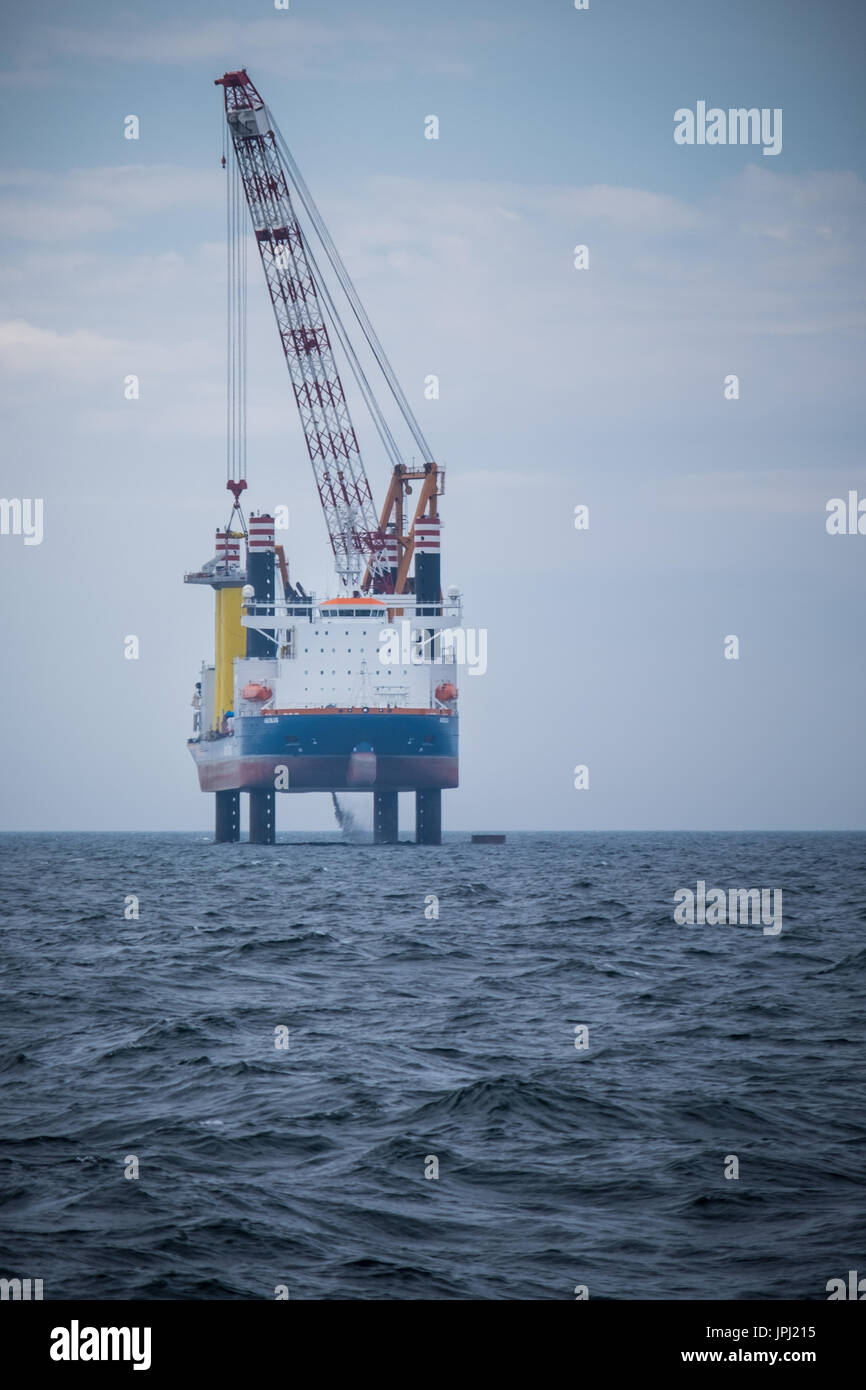 The jack-up vessel, Aeolus, installing the Transition Pieces (TP's) on the Walney Extension Offshore Wind Farm Stock Photo