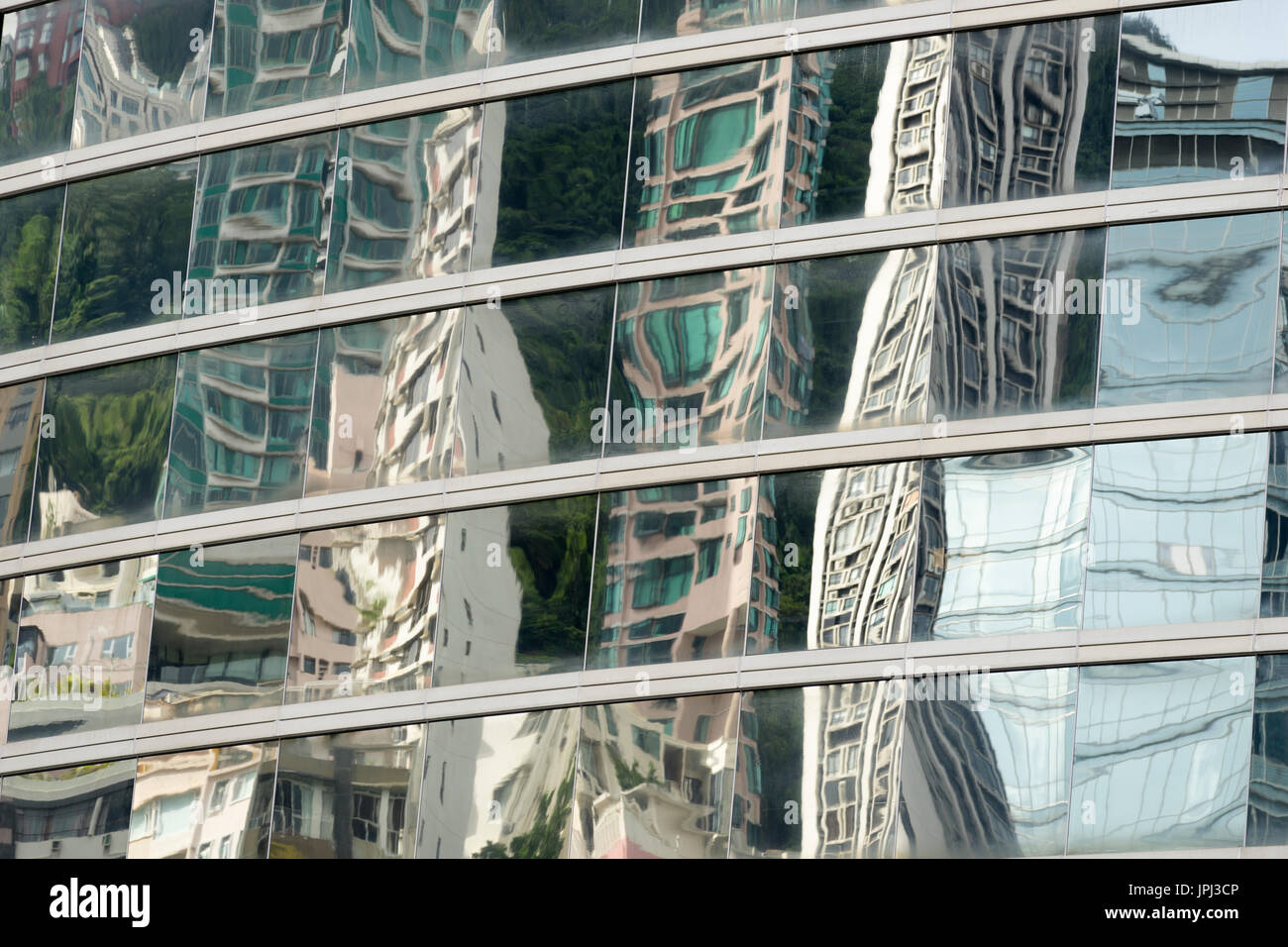 Skyscrapers reflected in the windows of highrise building creating interesting distorted patterns Stock Photo