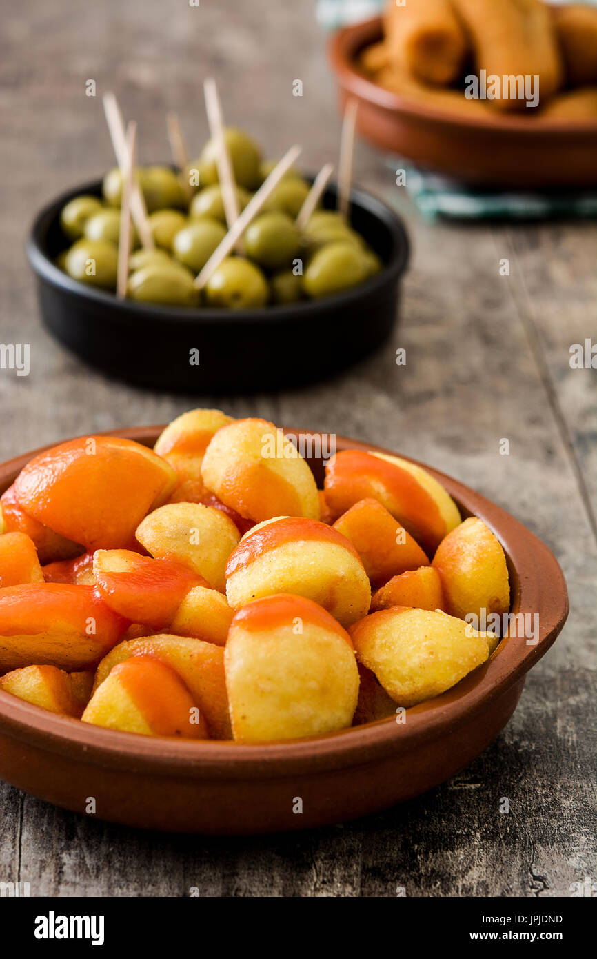 Traditional spanish tapas. Croquettes, olives and patatas bravas on wooden table Stock Photo