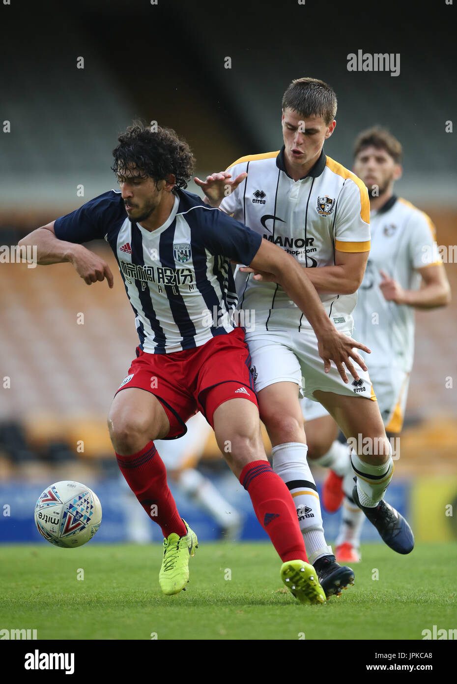 West Bromwich Albion's Ahmed Hegazy holds off challenge from Port Vale's Mike Calverley during the pre-season friendly match at Vale Park, Stoke. Stock Photo