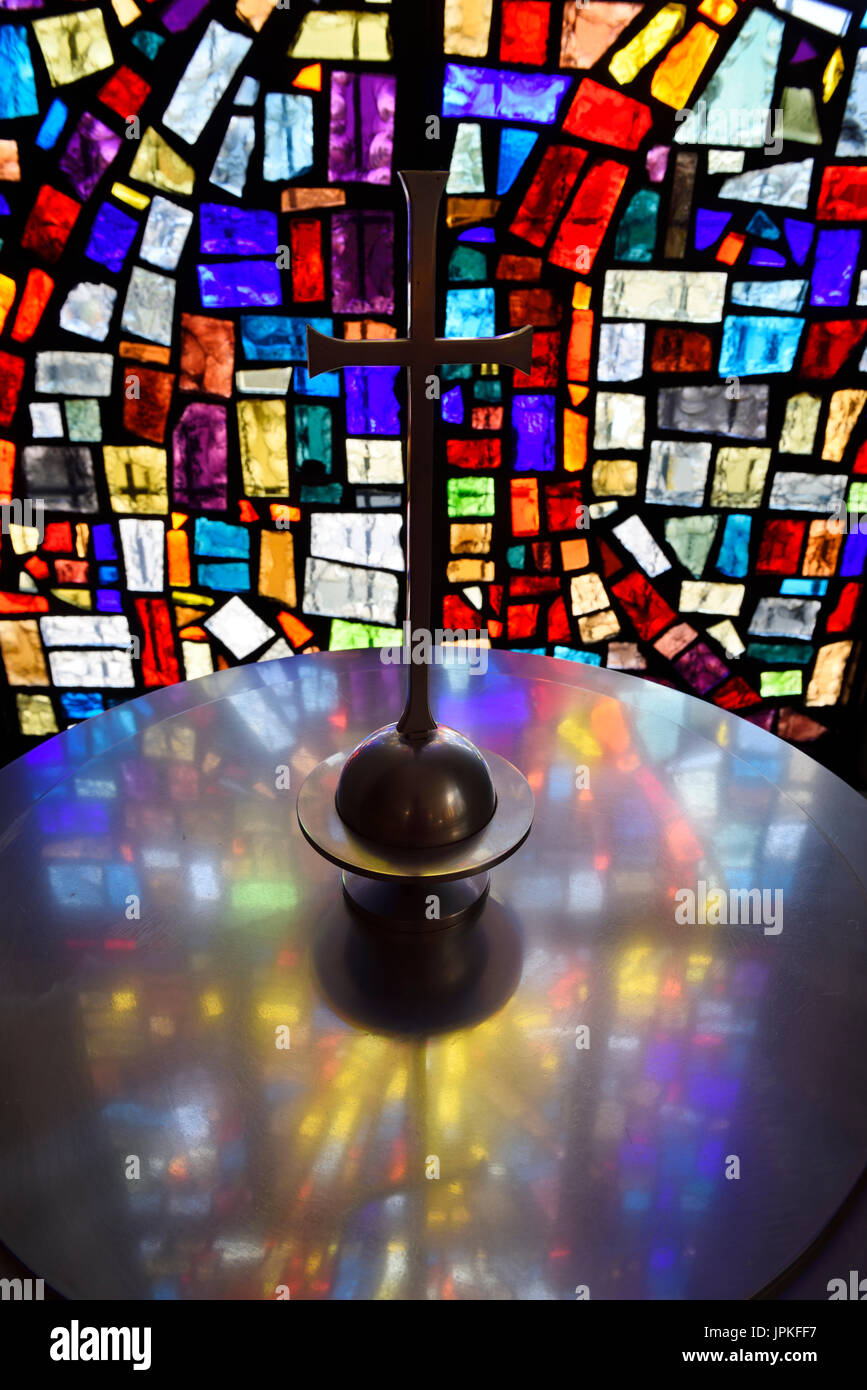 Abstract colors in a stained glass window mosaic at a baptismal font with cross in a Toronto Roman Catholic church Stock Photo