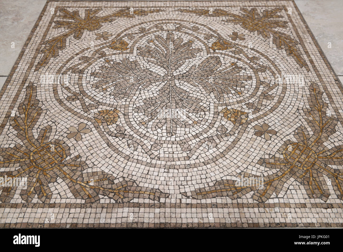 Flower design Cross of Saint Florian mosaic tiles on the floor of a Toronto Roman Catholic church Stock Photo