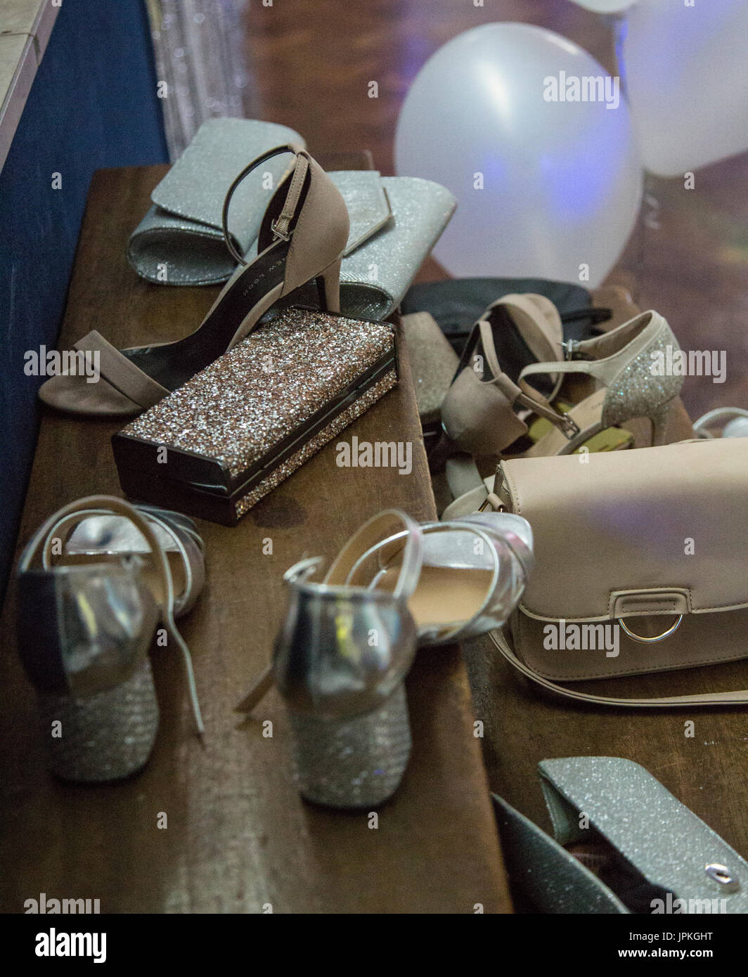 Shoes and handbags left on the stage whilst the girls dance the night away during their High School Prom Stock Photo