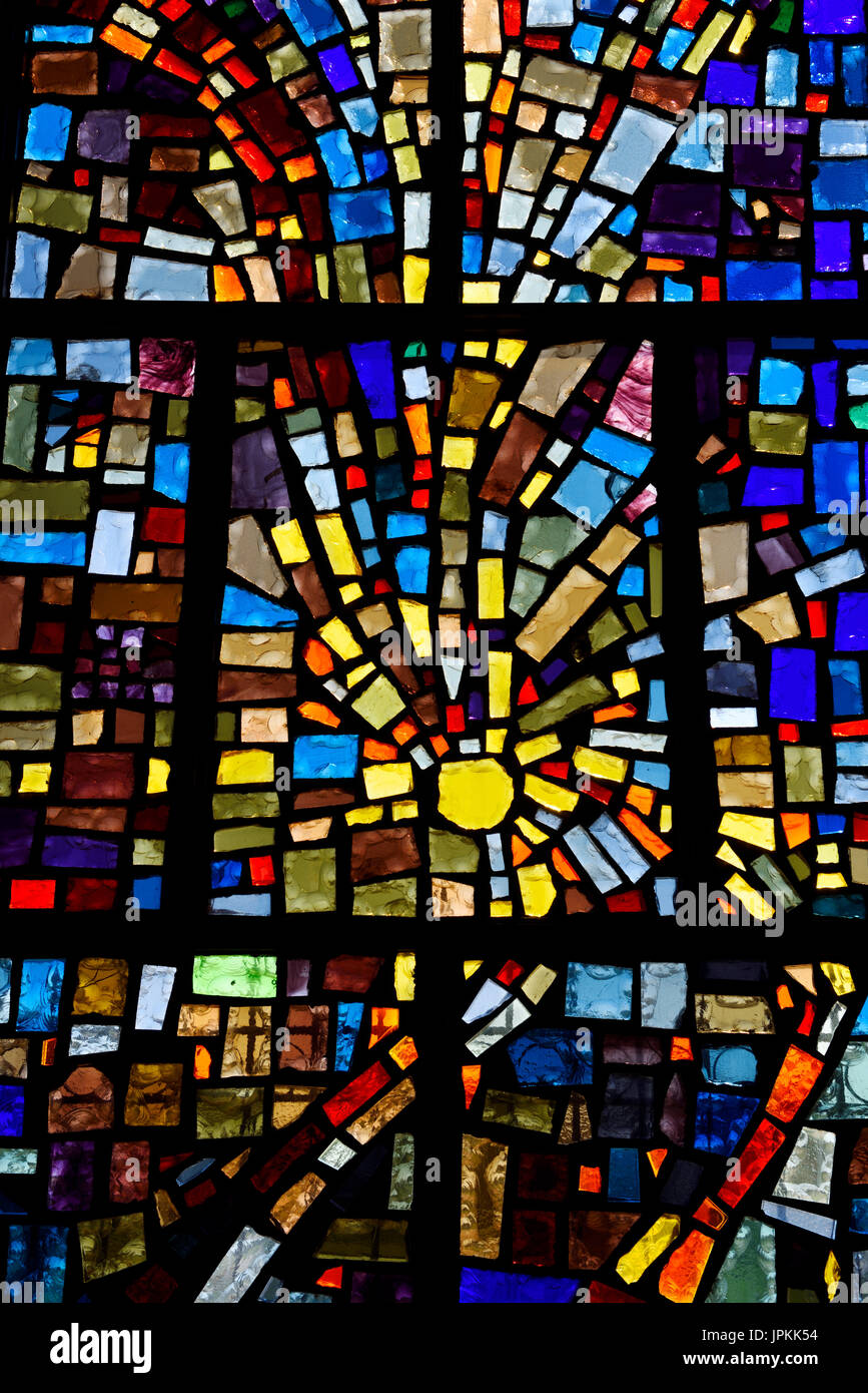 Abstract sun pattern of colors in a stained glass window mosaic in a Toronto Roman Catholic church Stock Photo