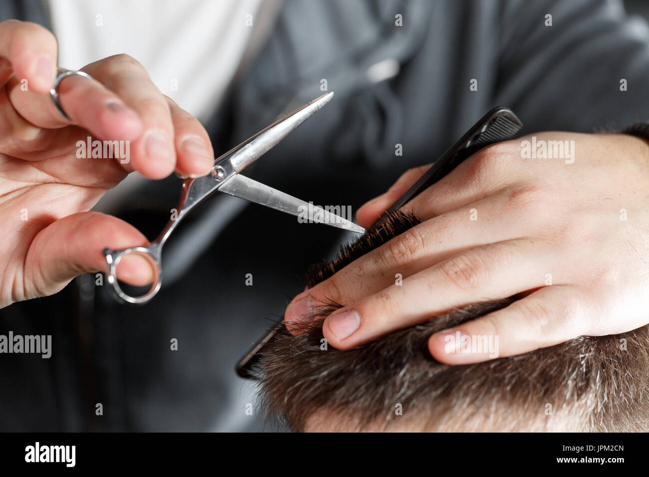 men's haircut with scissors at salon Stock Photo Alamy