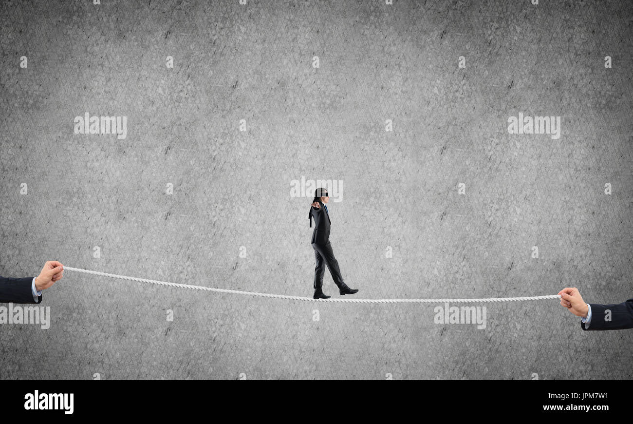 Business concept of risk support and assistance with man balancing on ...