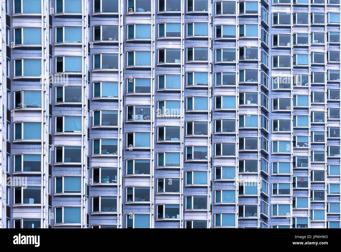 Small blue windows pattern on large building facade Stock Photo