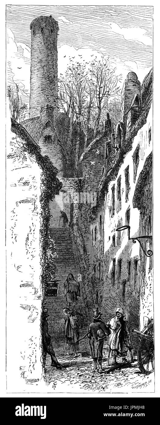 1870: An early-surviving flight of cut-limestone steps built by Robert Wale (Wall),  procurator of the adjacent Saint Canice's Cathedral in 1614. They lead through the  archway leads to the Round Tower of St Canice’s Cathedral. Irish Town, Kilkenny City, Ireland Stock Photo