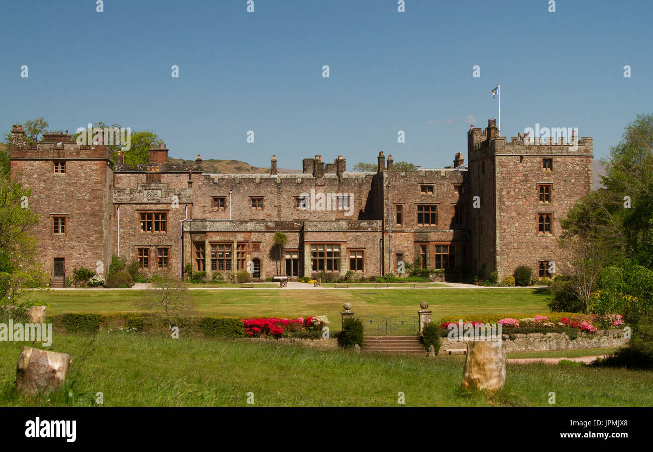 Historic Muncaster castle, stately home under blue sky in Cumbria, England Stock Photo