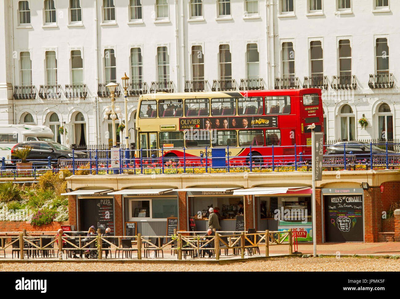 Red and cream double decker bus on main street of seaside town of Eastbourne, England Stock Photo