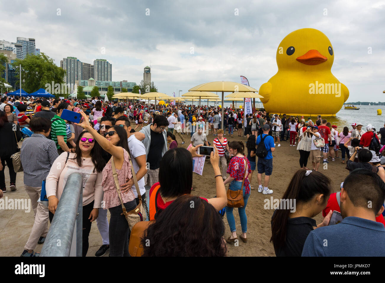 People crowd the HTO Park to take pictures and selfies of the World's Largest Rubber Duck during the Redpath Waterfront Festival as part of Canada 150 celebration in Toronto, Canada.  Featuring: Rubber duck Where: Toronto, Ontario, Canada When: 01 Jul 2017 Credit: Dominic Chan/WENN.com Stock Photo