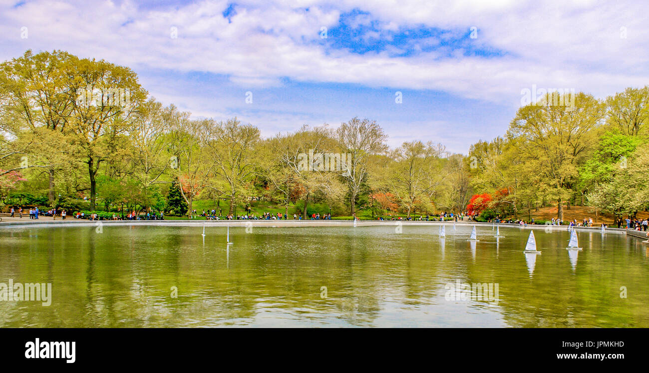New York City/Central Park April 11, 2009:  Remote controlled sailboats skim across the lake at Central Park on a gorgeous spring day Stock Photo