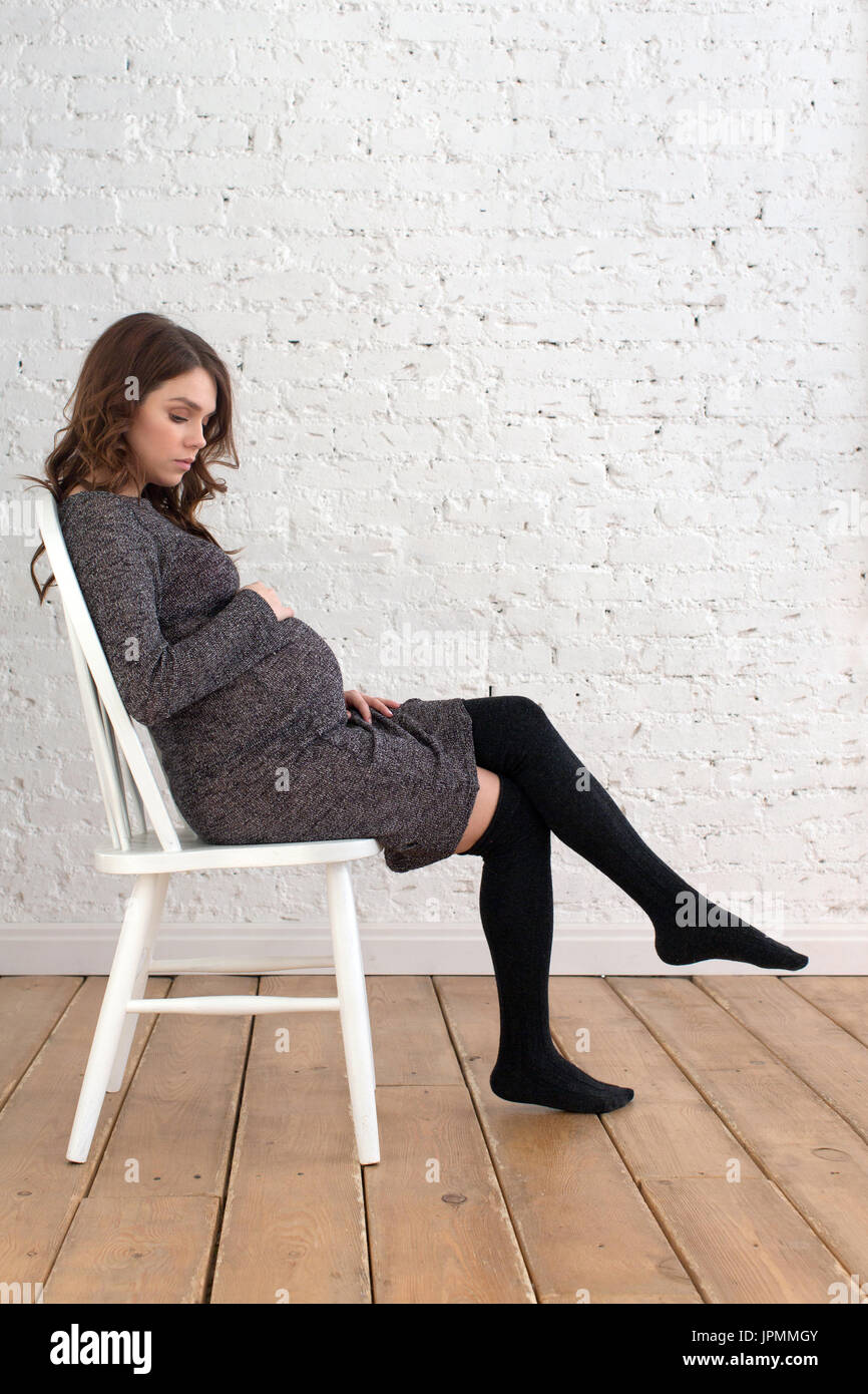 Portrait of pregnant female sitting on chair Stock Photo Alamy