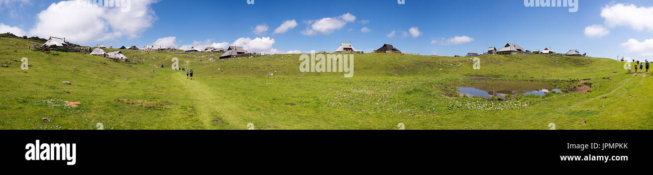 Extreme large panorama of Velika planina plateau, Slovenia, Mountain village in Alps, wooden houses in traditional style, popular hiking destination Stock Photo