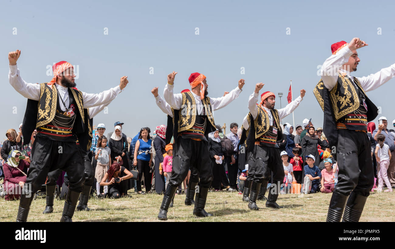 Unidentified people playing traditional folklore with their ethnic clothes at a show.It is popular in Turkey.ISTANBUL, TURKEY, May 13, 2017 Stock Photo