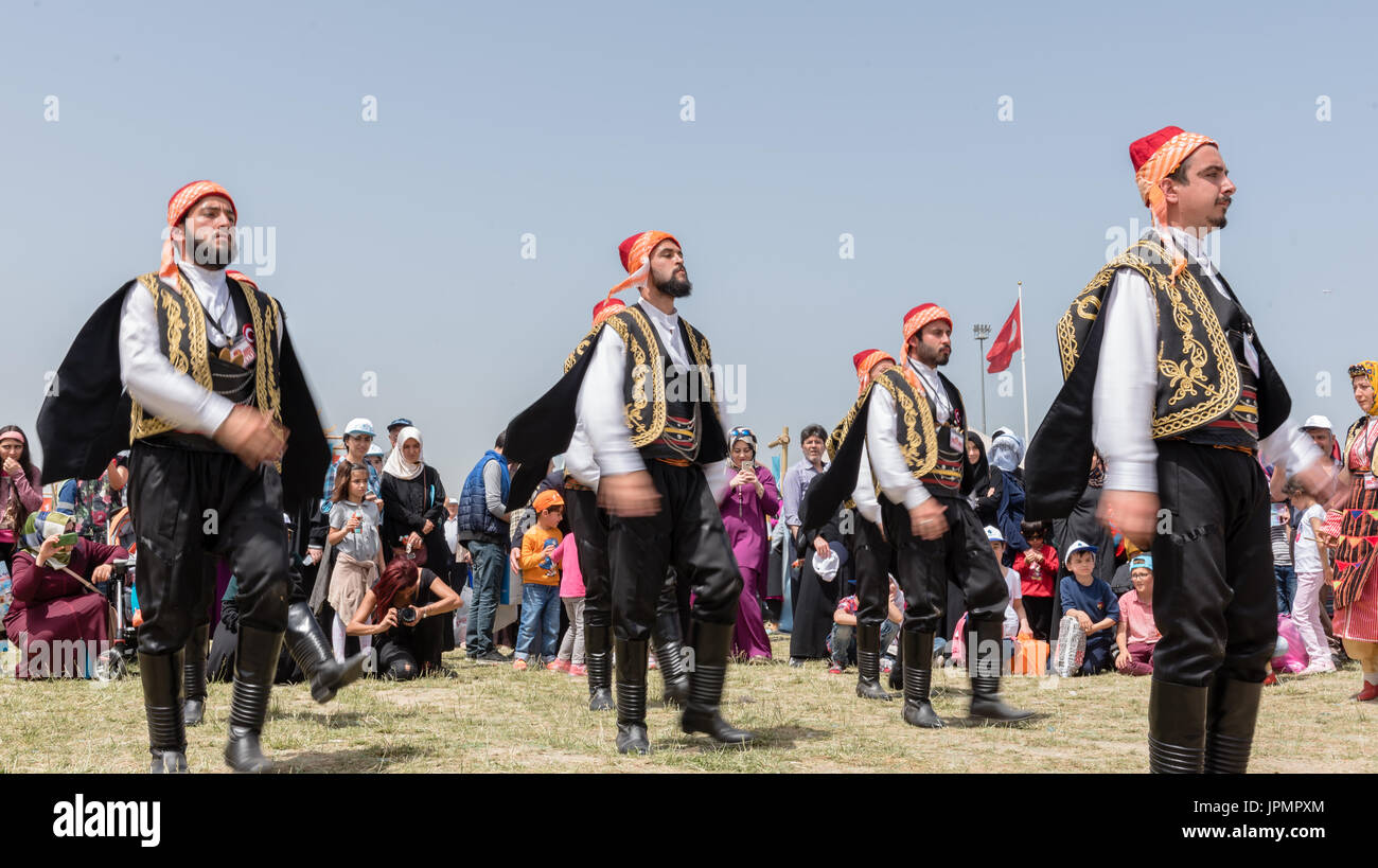Unidentified people playing traditional folklore with their ethnic clothes at a show.It is popular in Turkey.ISTANBUL, TURKEY, May 13, 2017 Stock Photo