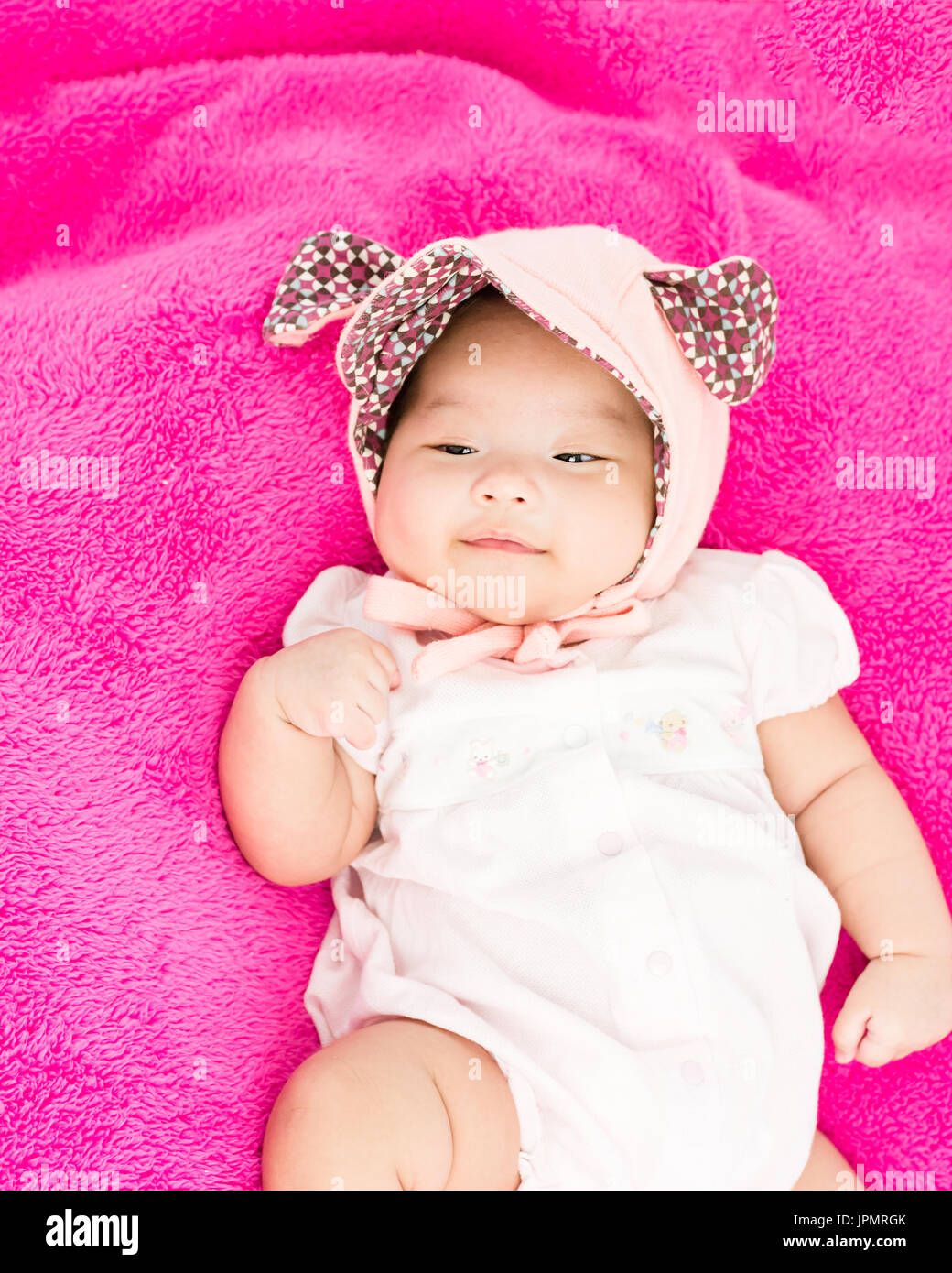 Portrait of sleeping baby lying on blanket with head band Stock Photo