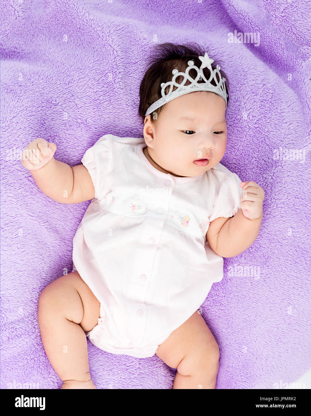Portrait of sleeping baby lying on blanket with head band Stock Photo