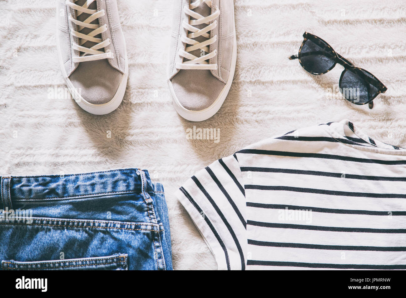 flat lay women fashion. trendy hipster clothes and accessories top view.  outfit collage with jeans, striped t-shirt, grey plimsolls and sunglasses  Stock Photo - Alamy