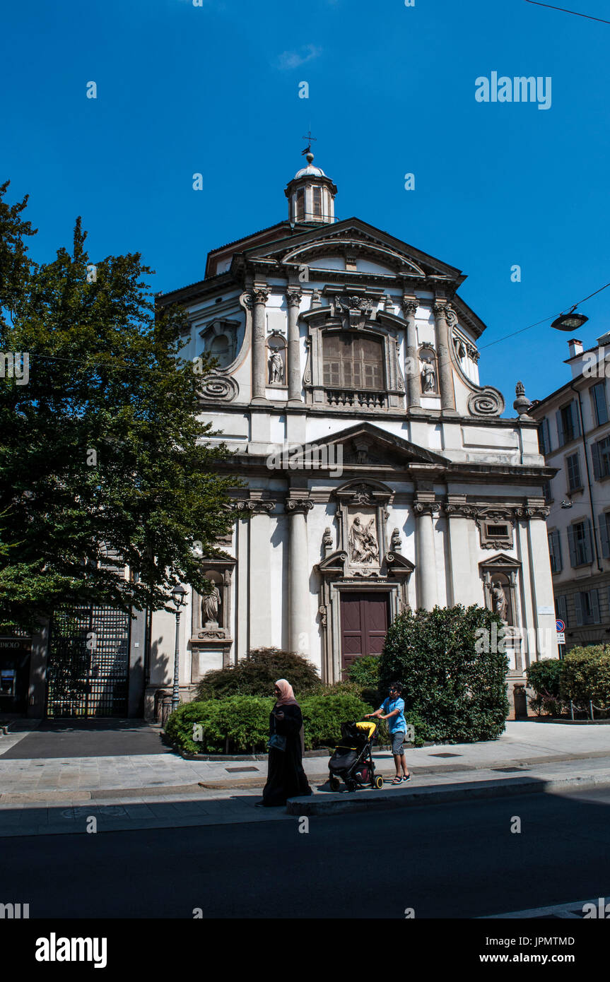 Milan, Italy: a muslim woman with hers children on front of the church of St. Joseph, among the most representative buildings of the Lombard baroque Stock Photo