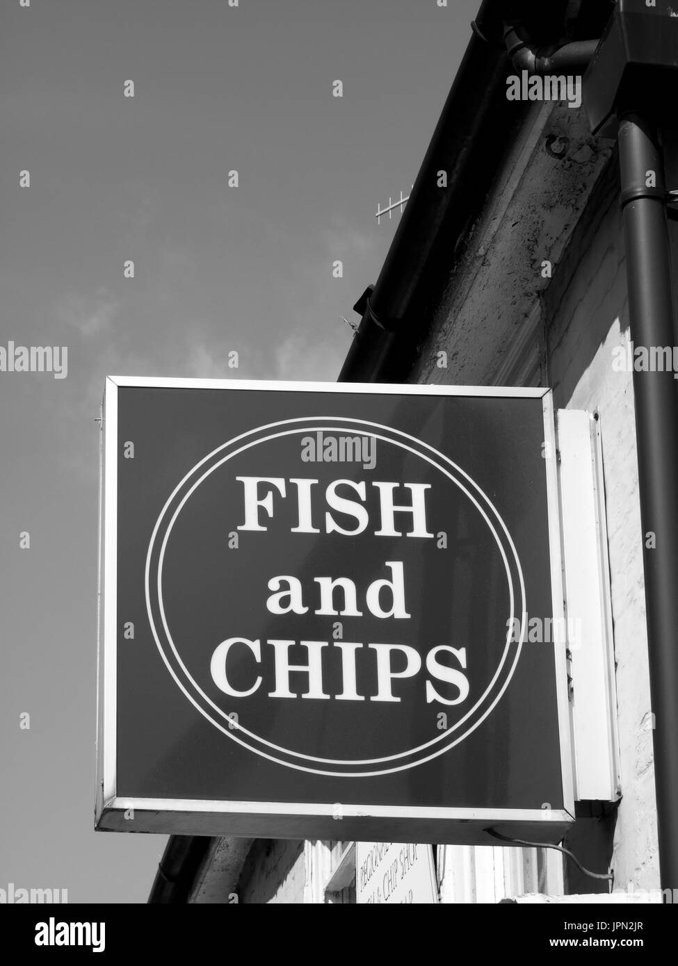 Sign over premises advertising the traditional English cuisine of fish and chips Stock Photo