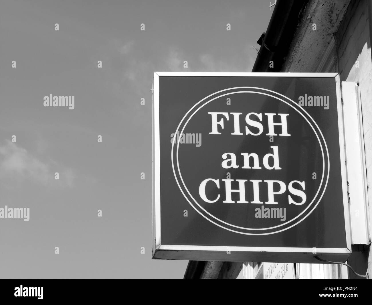 Sign over premises advertising the traditional English cuisine of fish and chips Stock Photo