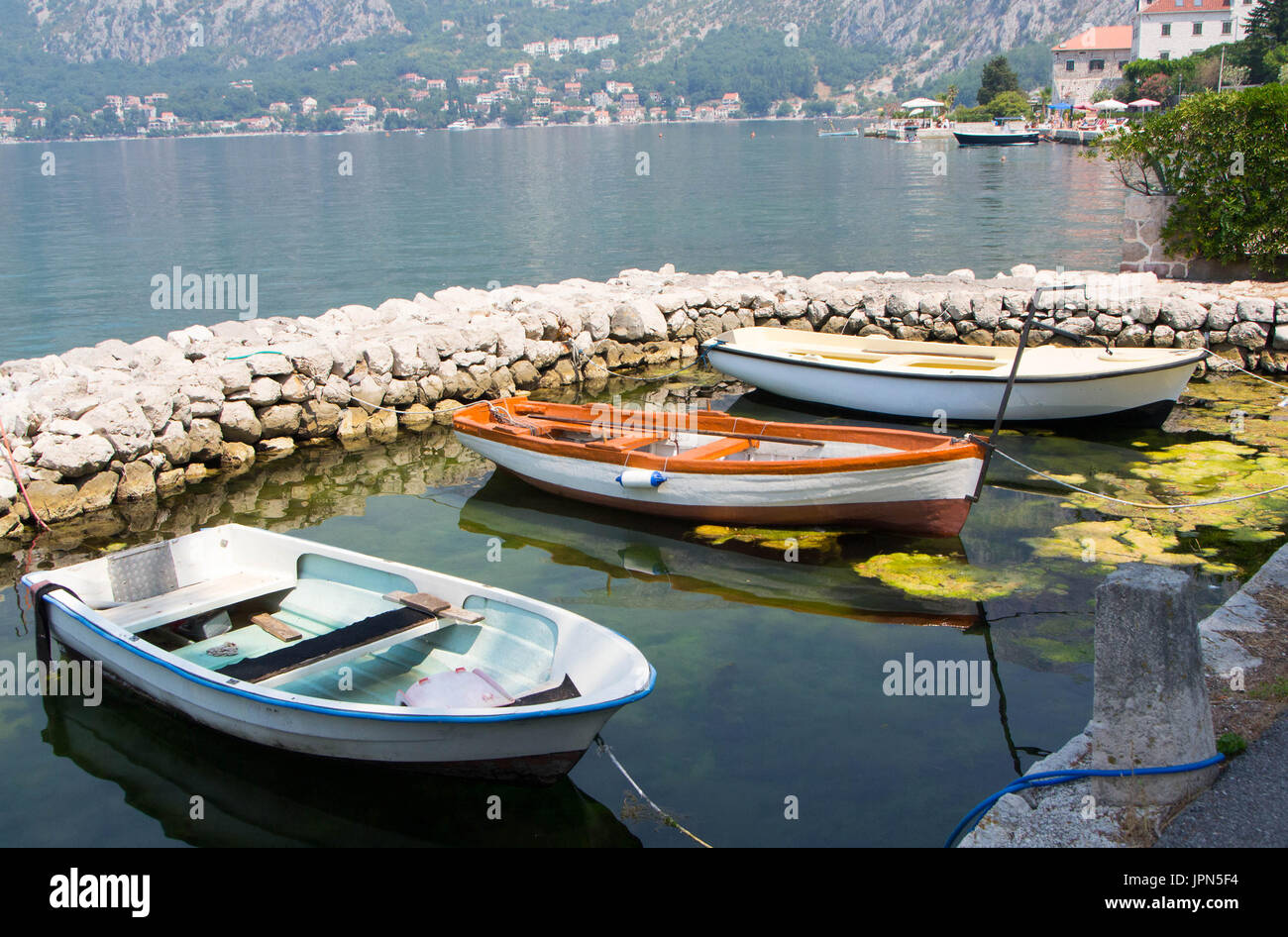 An old wooden fishing boat moored in a small harbor Stock Photo - Alamy