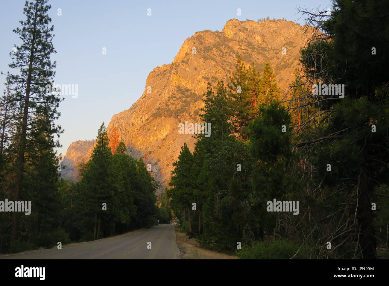 Bluffs rising, granite dome above road  in  upper King's Canyon, King's Canyon National Park, California, United States Stock Photo