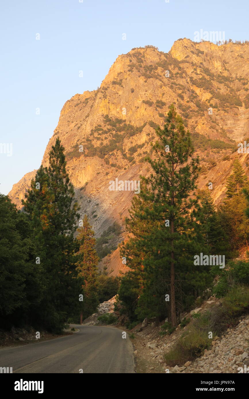 Bluffs rising, granite dome above road  in  upper King's Canyon, King's Canyon National Park, California, United States Stock Photo