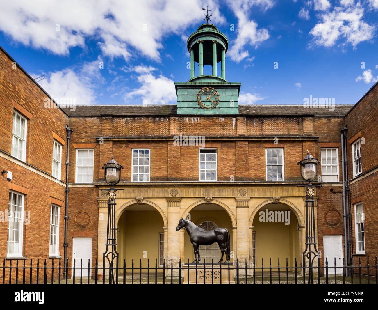 Jockey Club Newmarket - Front Facade of the Jockey Club Rooms in Newmarket Suffolk with a statue of Hyperion, a famous Newmarket horse. Stock Photo