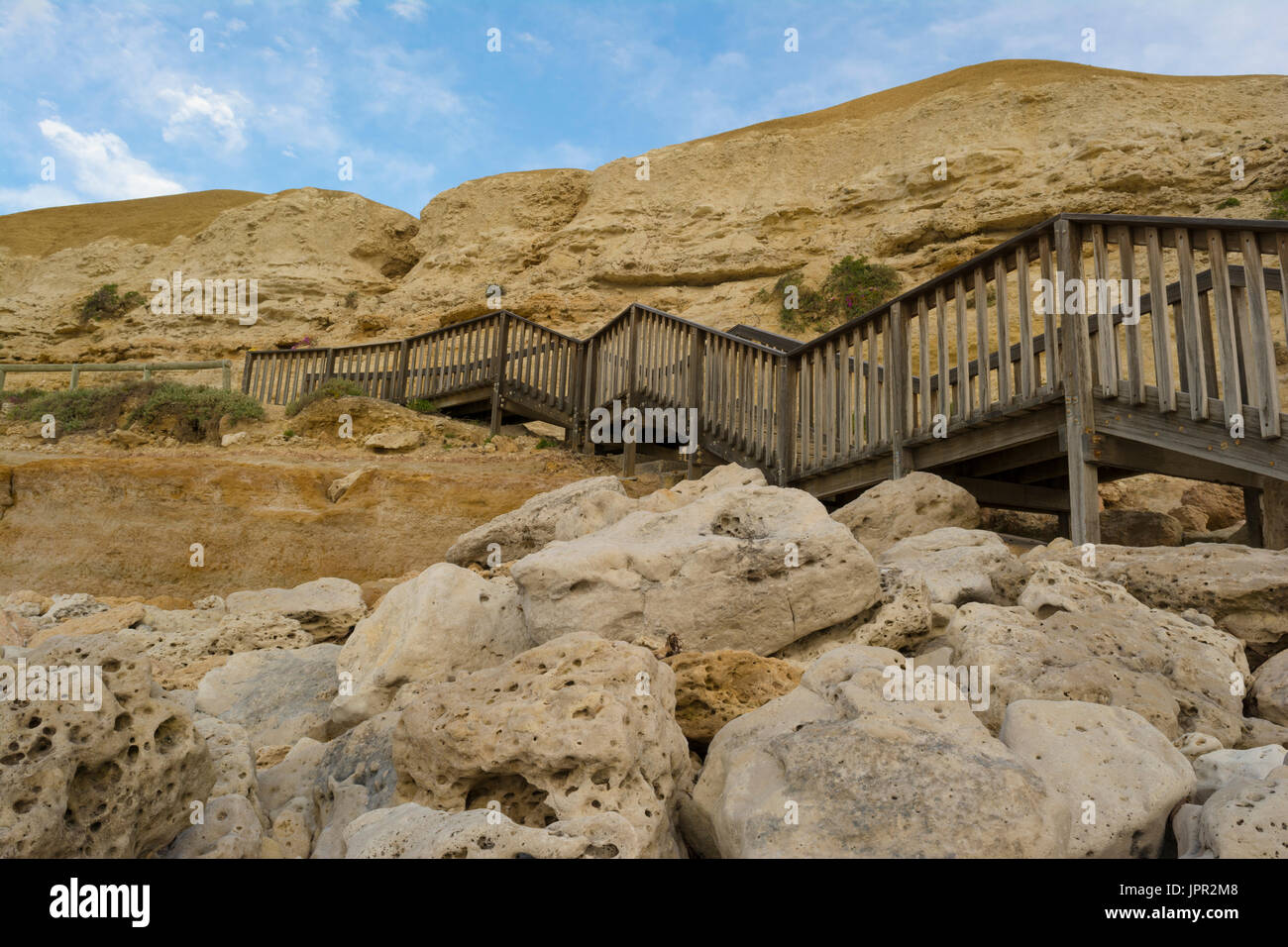 Stairs leading to the jetty ruins at Port Willunga Beach, South Australia, coming down from the cliffs,  just prior to sunset. Stock Photo