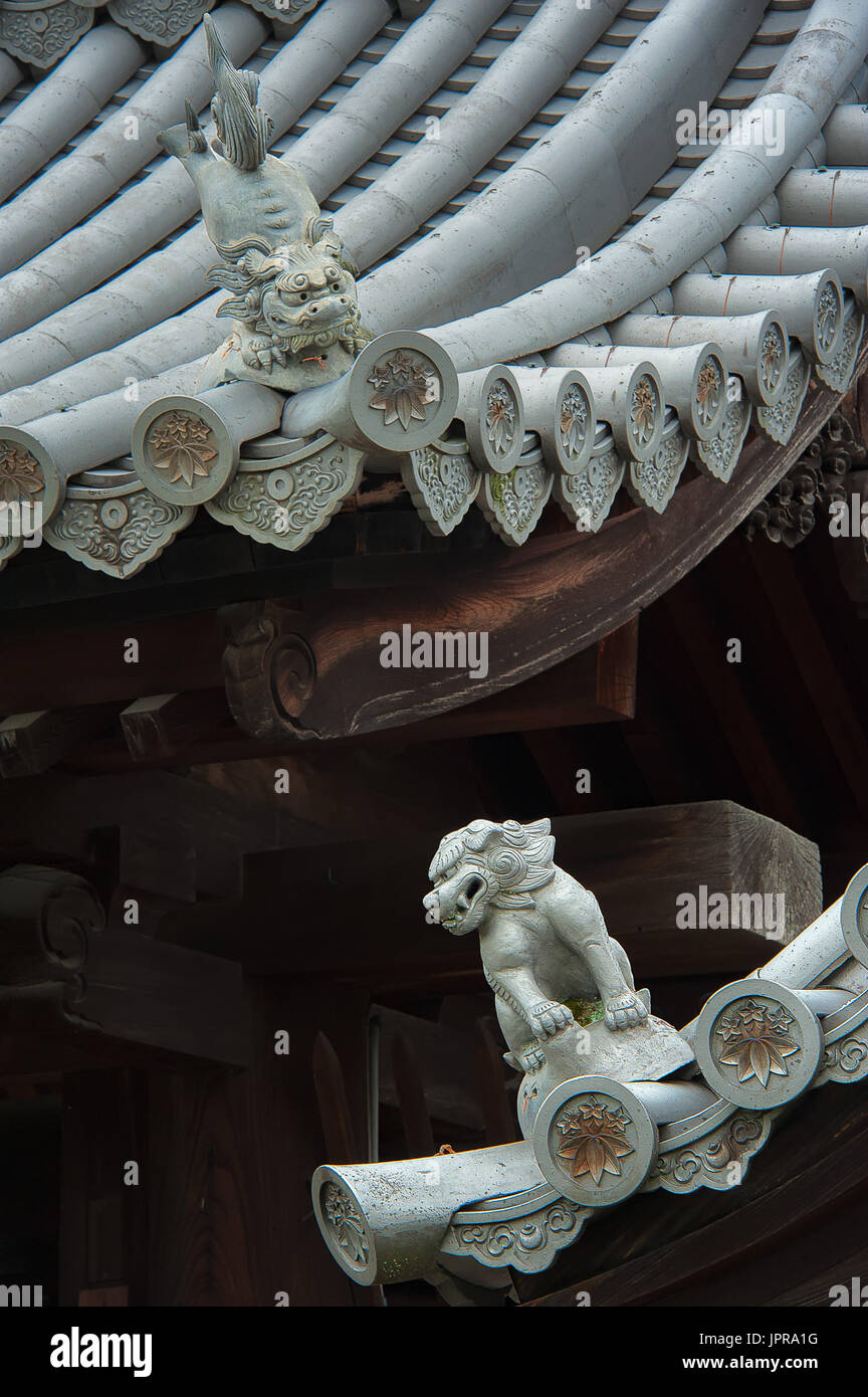 The mystical roof guardians set to watch over men and women behaviour and faithfulness. Commonly used as part of ancient Japanese architecture. Stock Photo