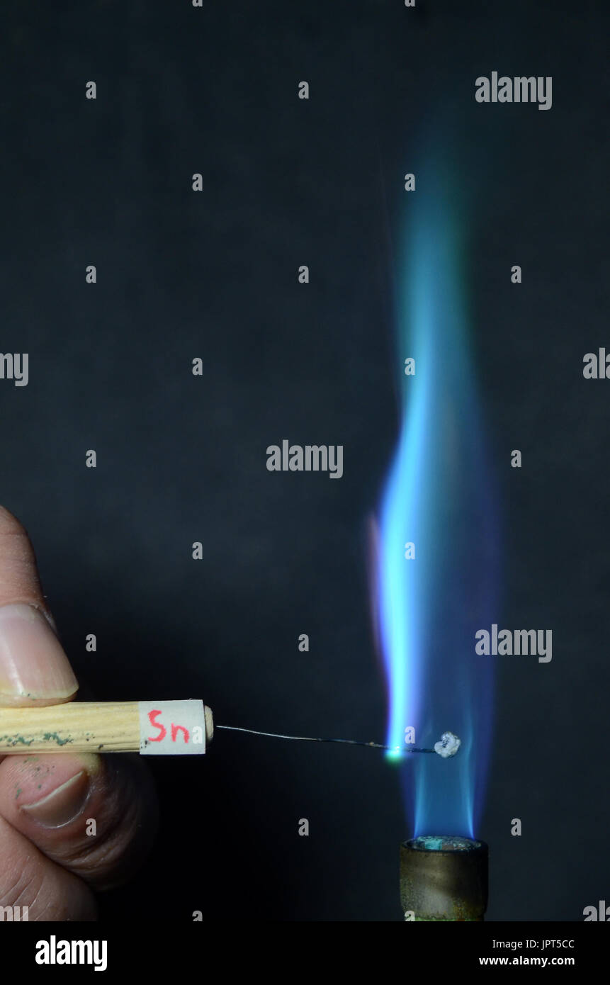 Colored fire caused by an element. Tin (Sn) causes a light blue color. Stock Photo