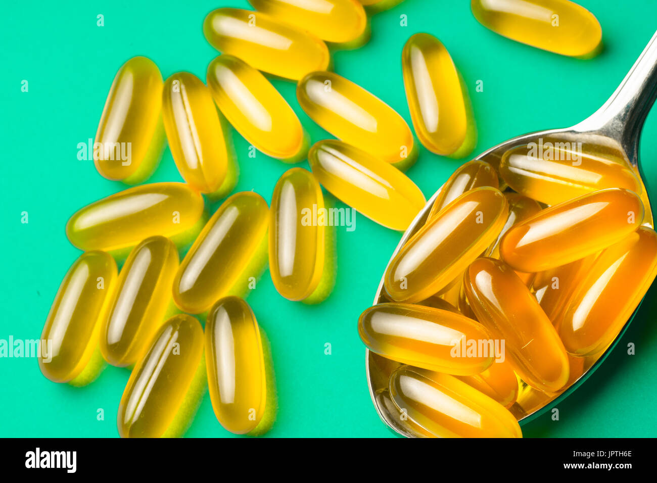 Vitamin e. Fish oil capsules on blue background. Copy space for your text,  high resolution product Stock Photo - Alamy