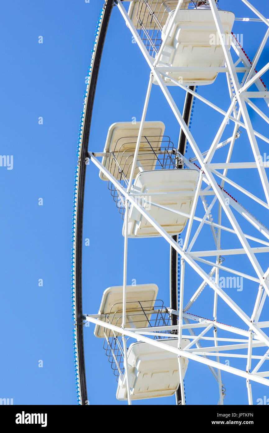 Panoramic wheel . Underside view of a ferris wheel rotating downward . Stock Photo