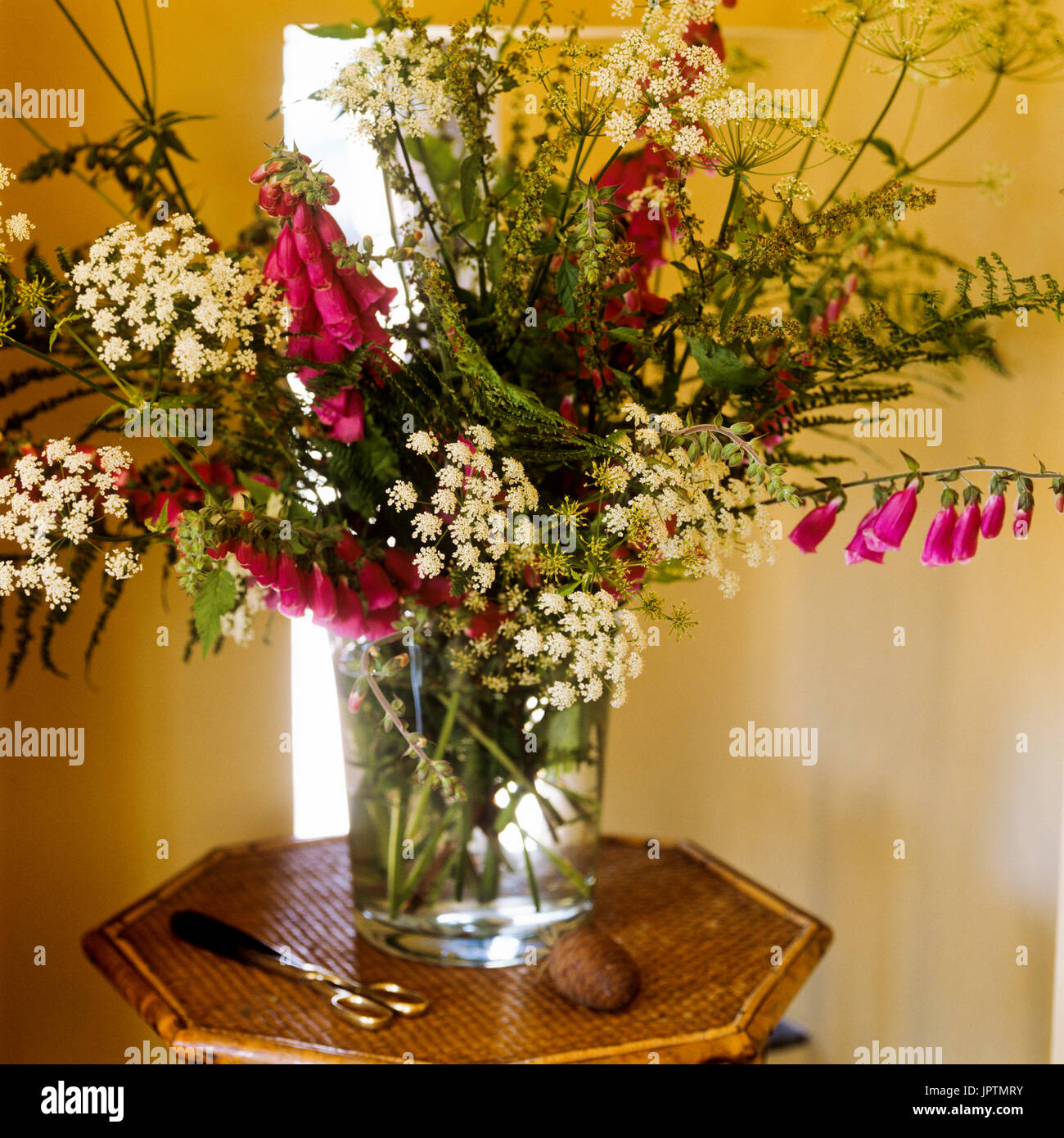 Flowers and scissors on table Stock Photo