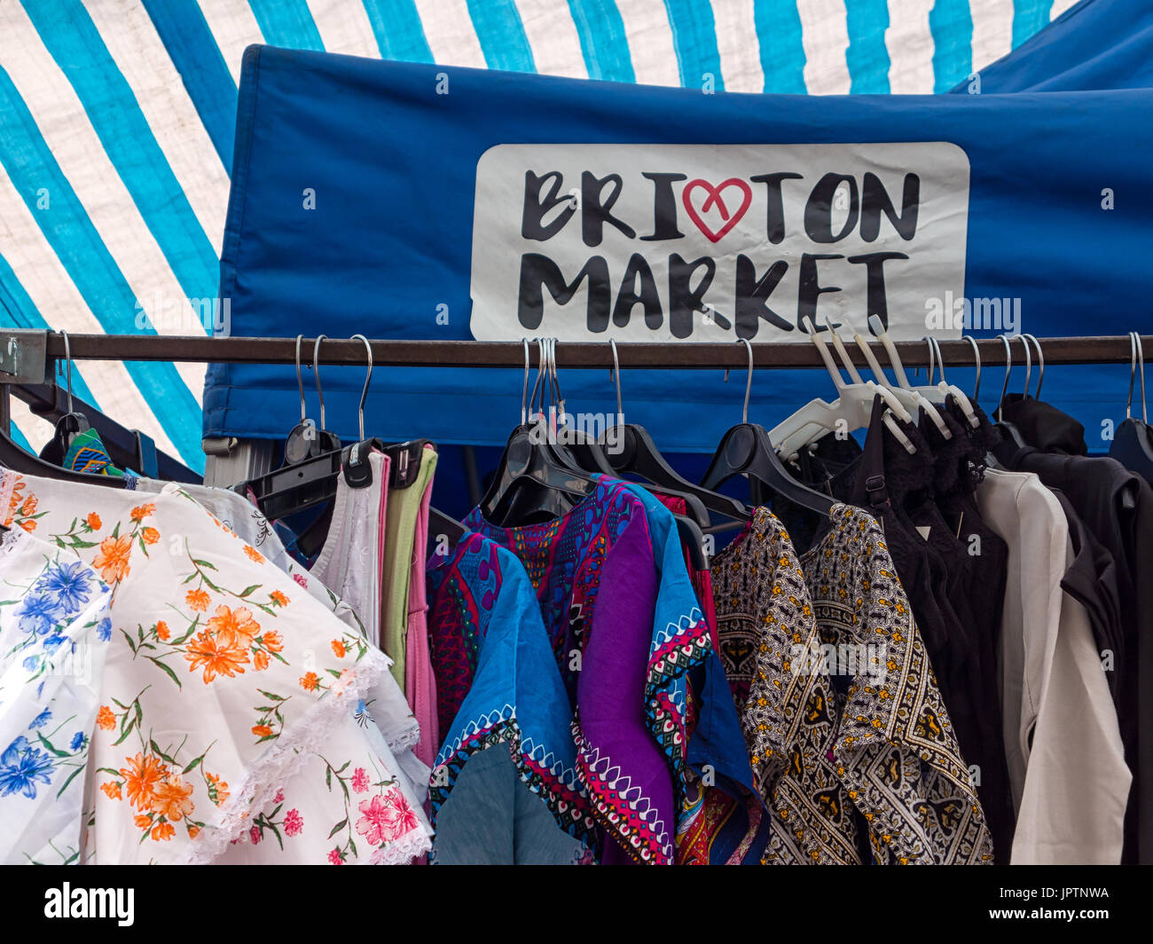 LONDON, UK - JULY 29, 2017:  Clothing Stall on Brixton Market in Electric Avenue with sign Stock Photo