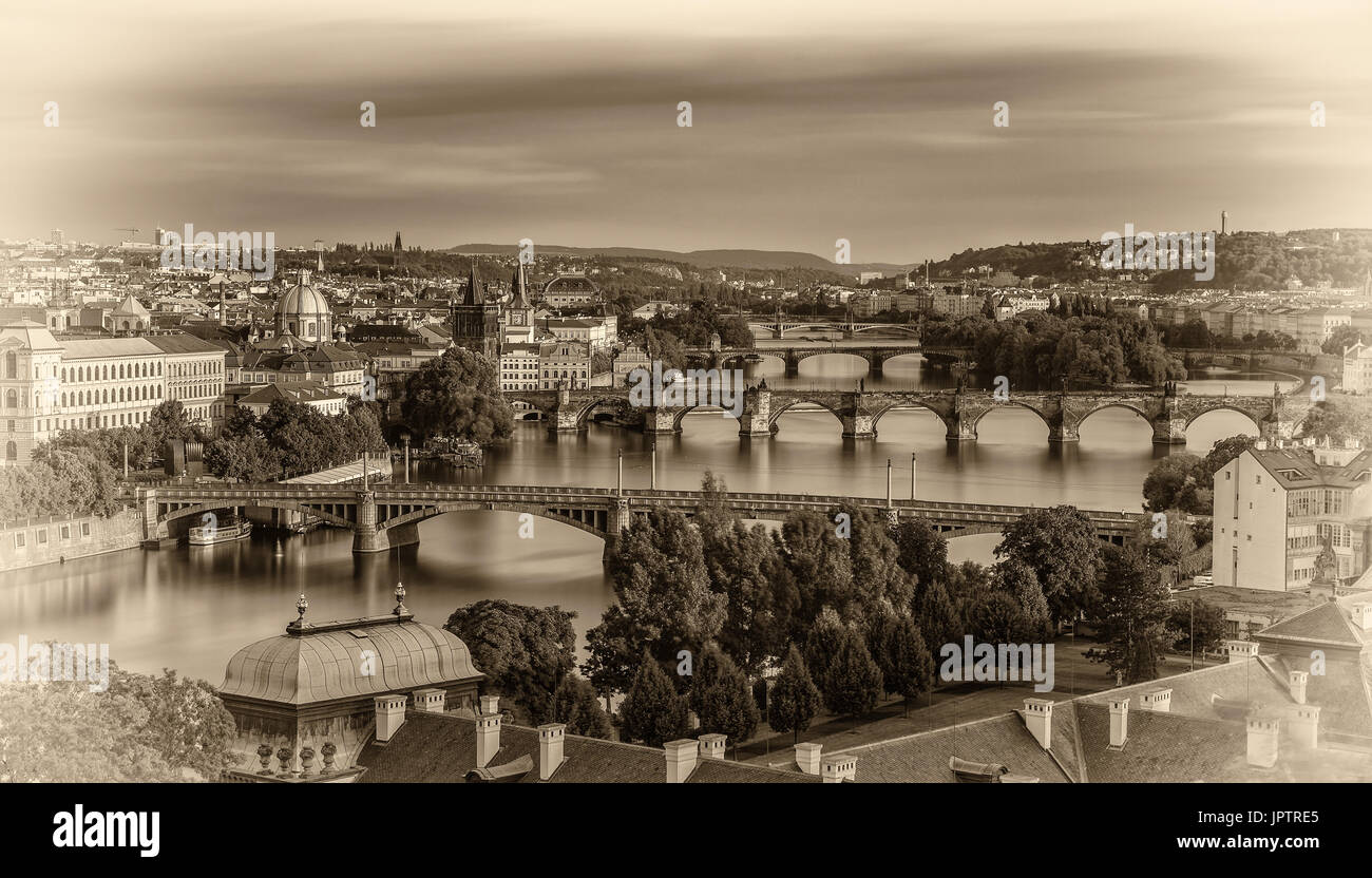 Historic bridges of Prague at the golden hour photographed from Letna park. Vintage black and white processed. Stock Photo