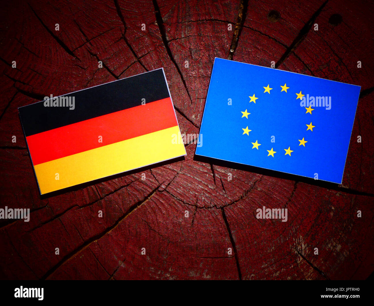 German flag with EU flag on a tree stump isolated Stock Photo - Alamy