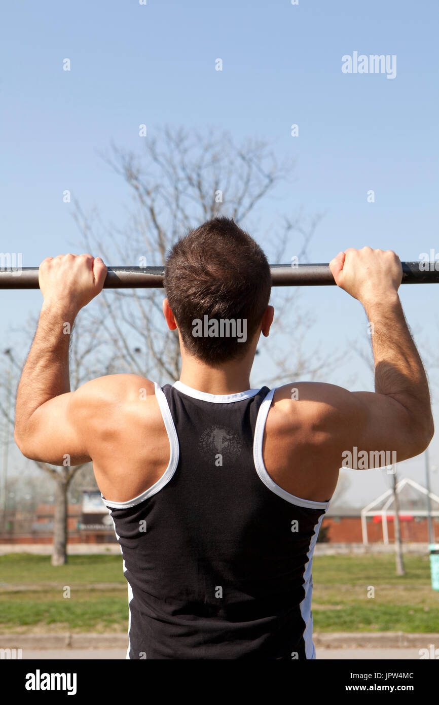 man does pullups at the park Stock Photo Alamy