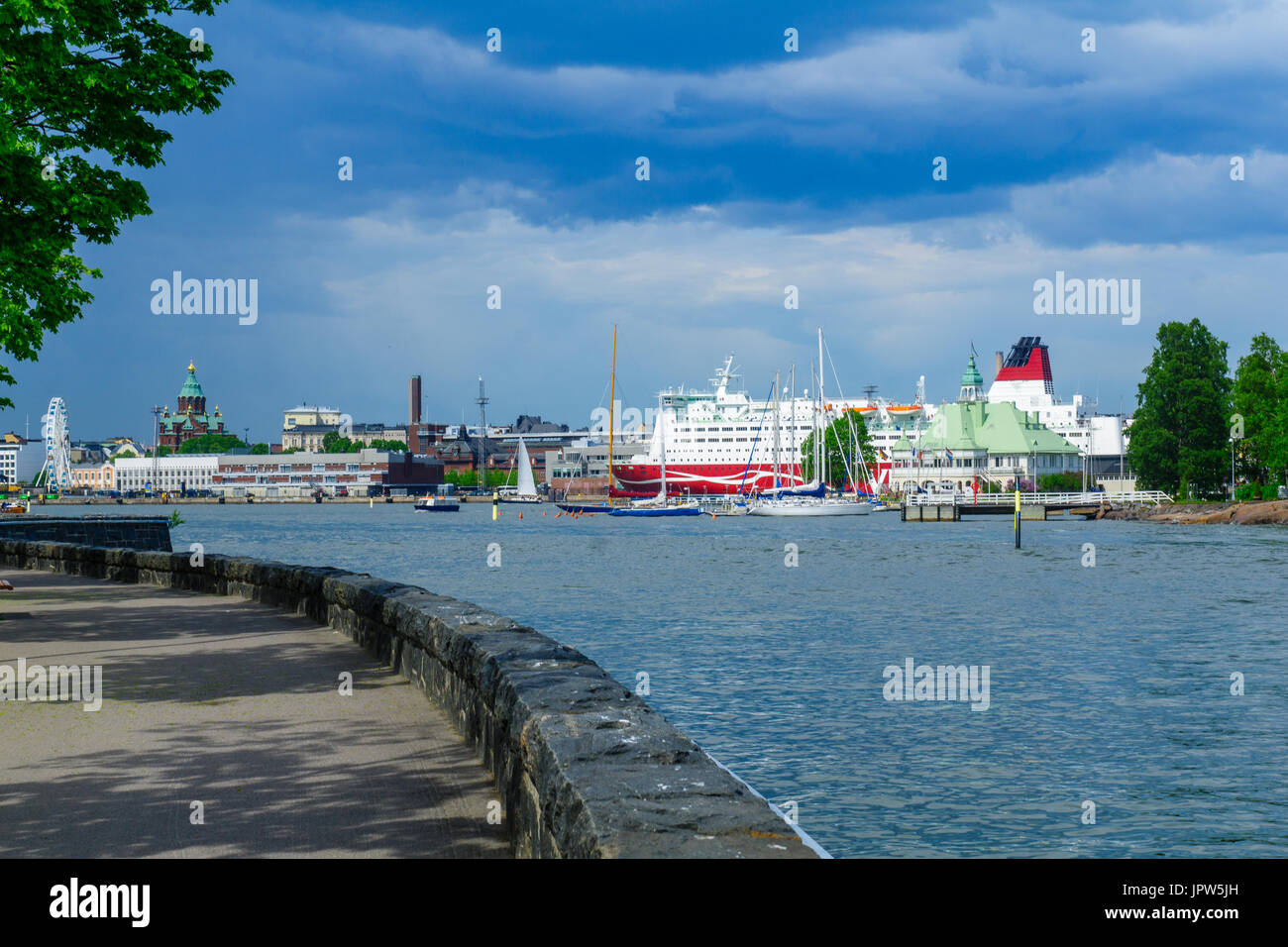 View of the Luoto island, with the promenade, ferry boats, the Russian Orthodox Uspenski Cathedral, and the SkyWheel in Helsinki, Finland Stock Photo