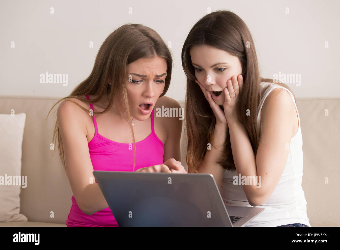 Teens excited with low prices during online sale Stock Photo