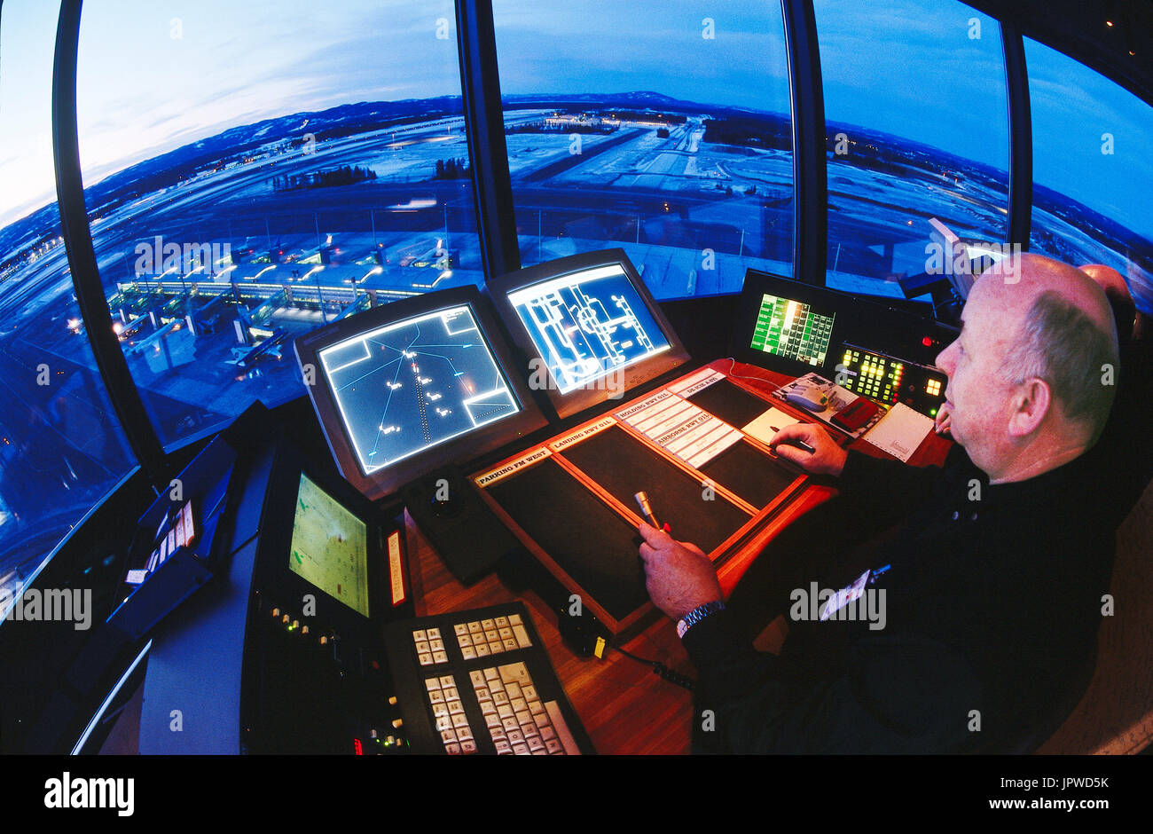 ATC-controller at radar screen with microphone and control strips in ...