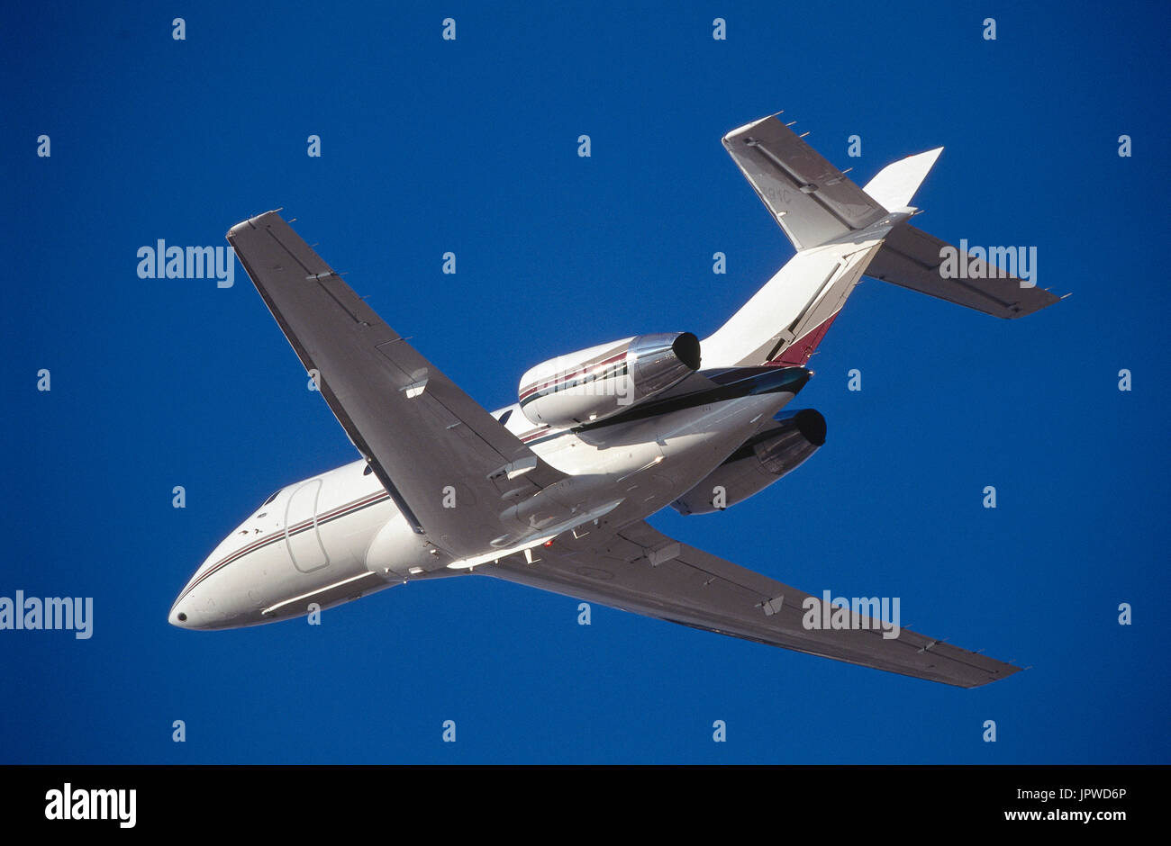 Hawker 800 business-jet climbing-enroute into a dark blue sky Stock Photo