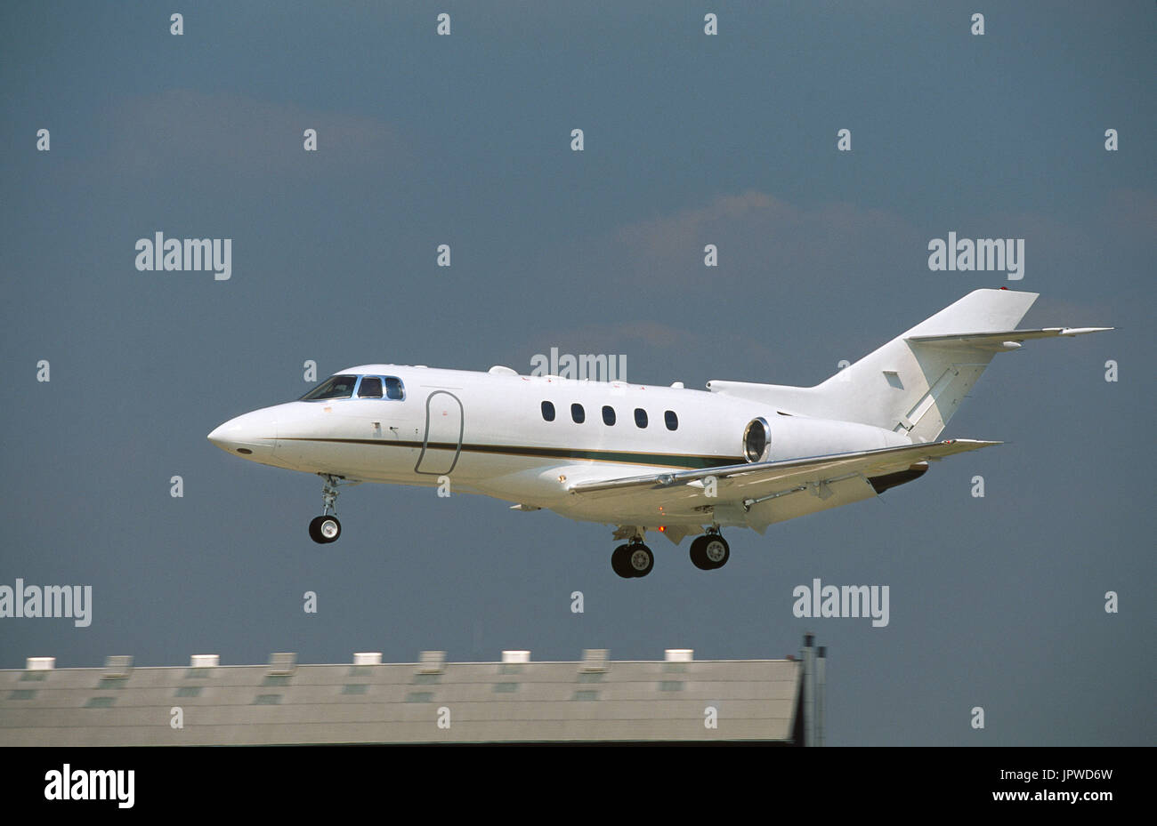 Hawker 800 business-jet on final-approach over the Black Sheds roof behind Stock Photo