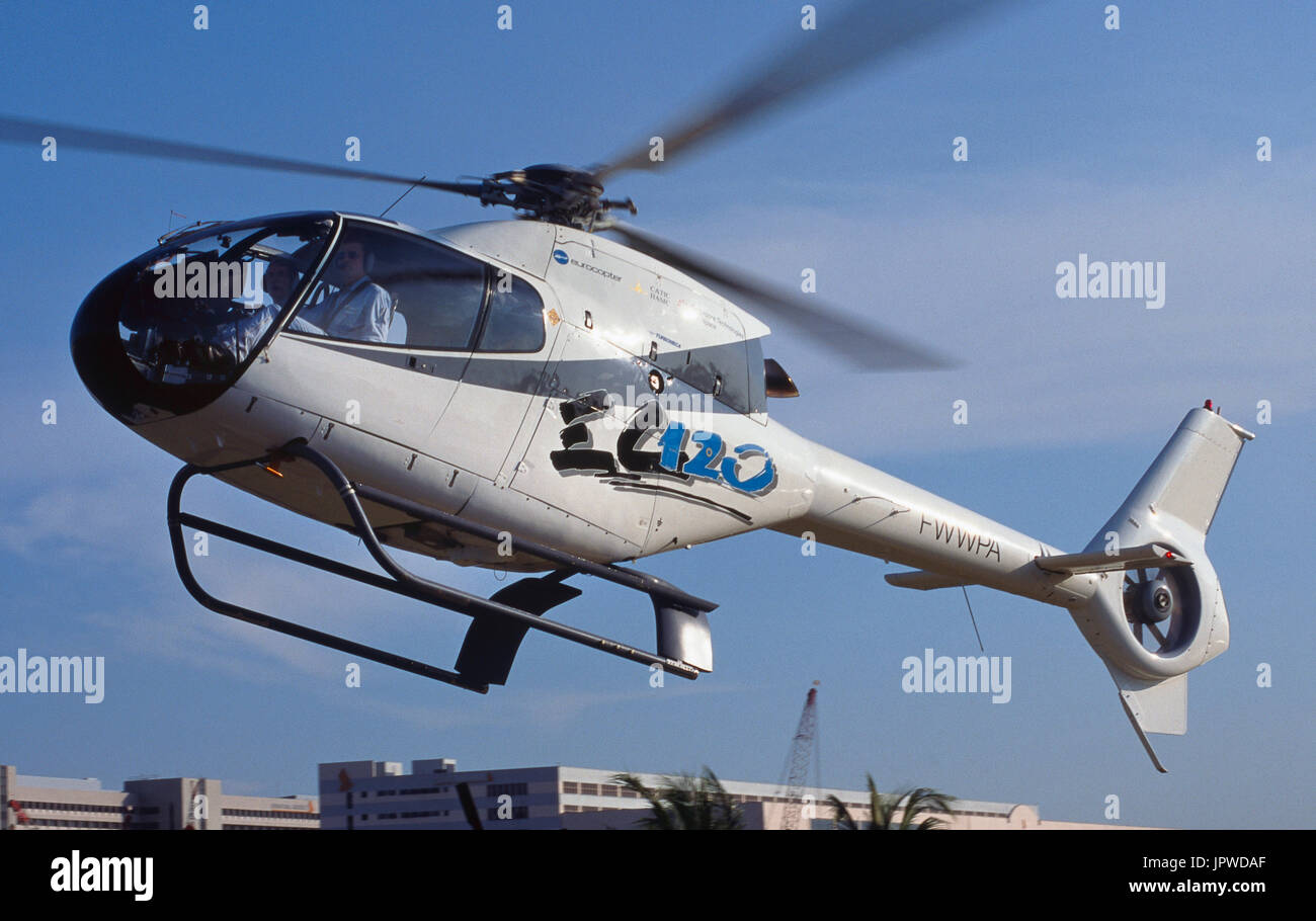Eurocopter EC-120 Colibri prototype landing with skyscrapers behind Stock Photo