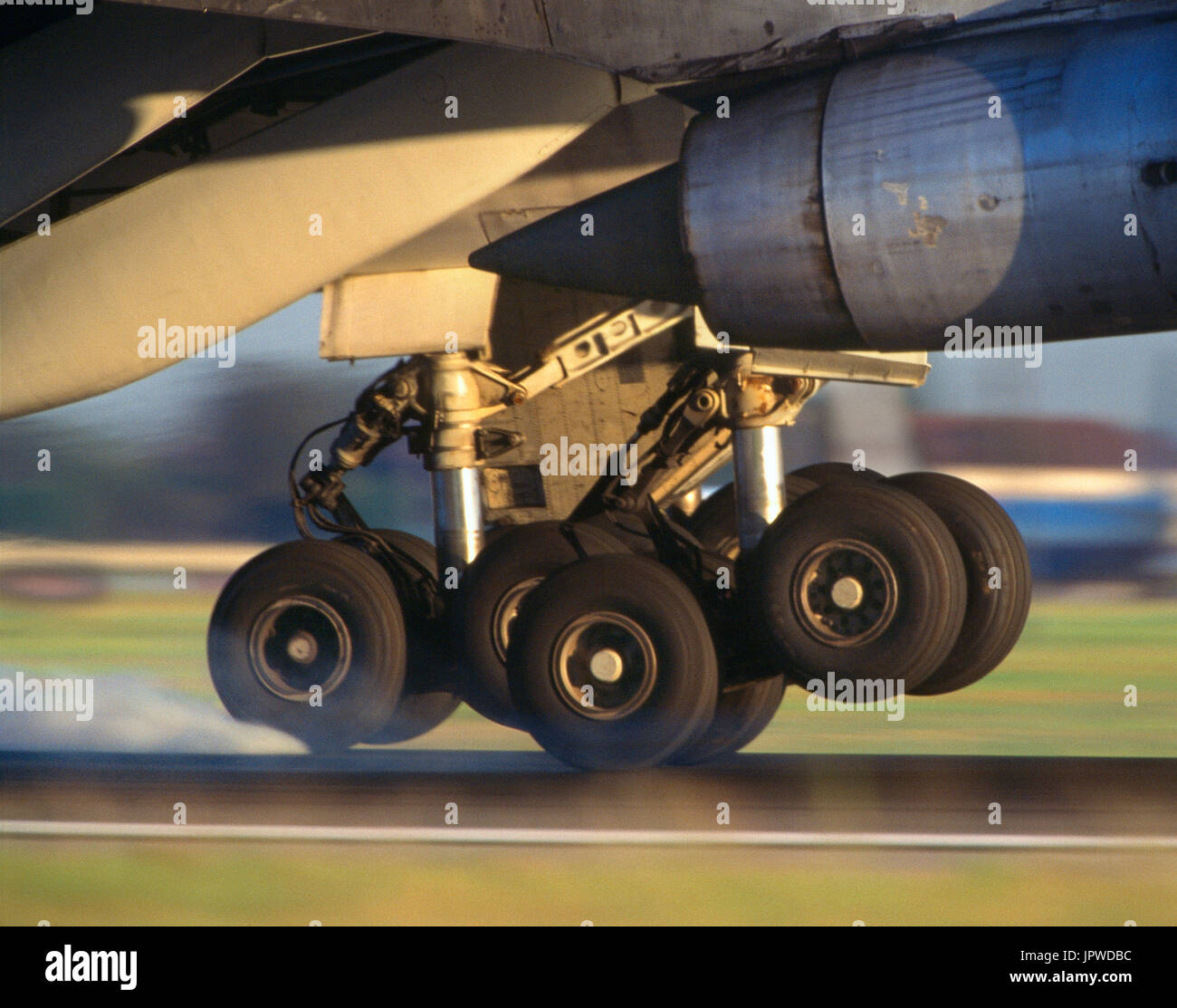 jet-engine, boat-fairing and mainwheel undercarriage of a Boeing 747 with smoking-tyres at touchdown Stock Photo