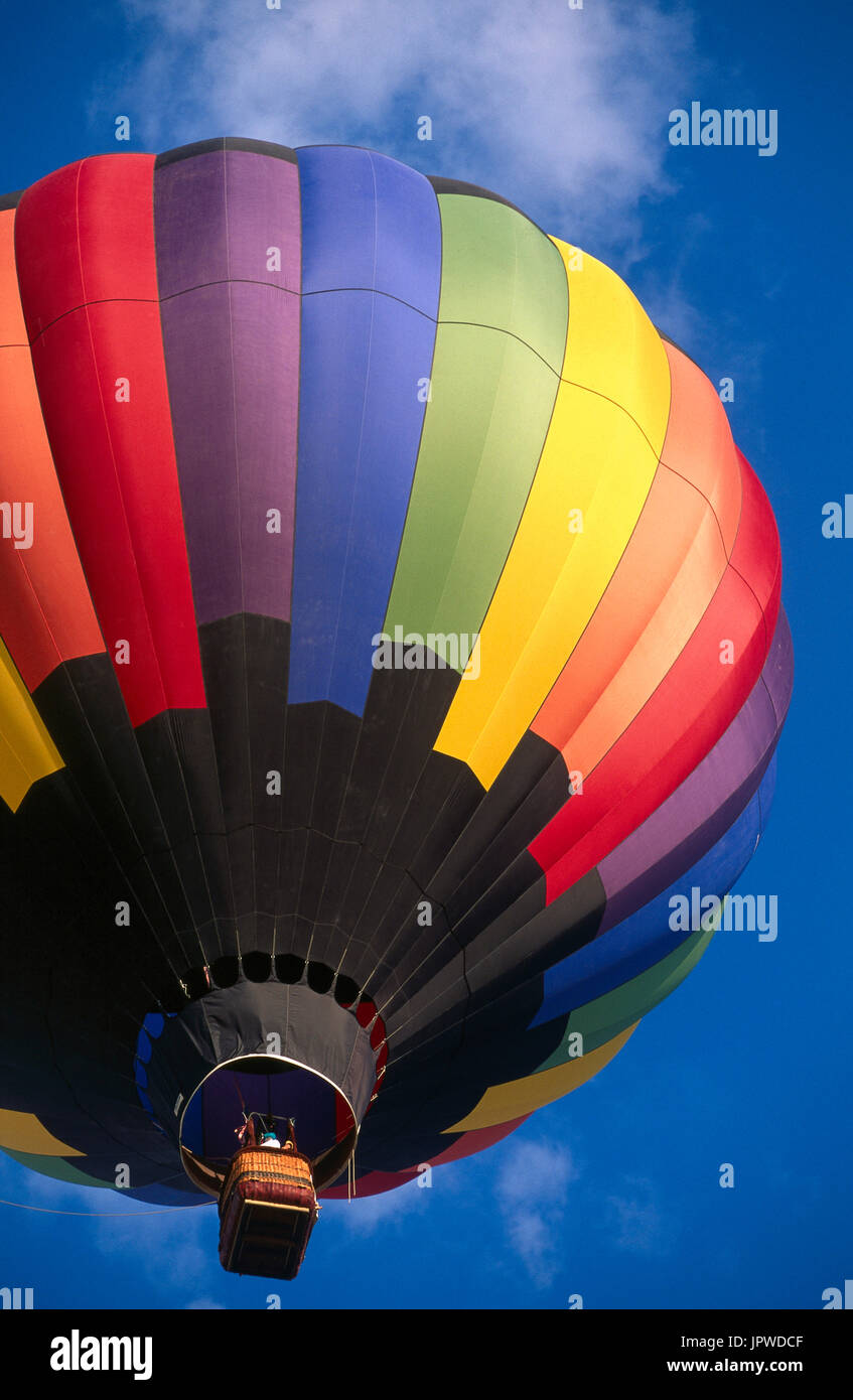 multi-coloured hot-air balloon flying enroute at the 1997 Albuquerque International Balloon Fiesta Stock Photo